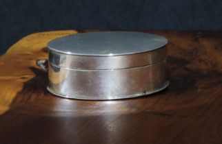 A George III silver oval nutmeg grater, quite plain, hinged cover and hinged compartment to base,