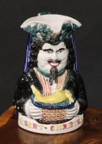 A Staffordshire pearlware novelty toby jug, Merry Christmas, modelled as a bearded figure holding