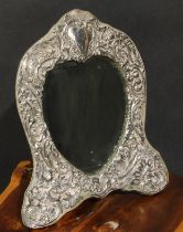 An Edwardian silver easel dressing table mirror, pierced and embossed with flowers and scrolling