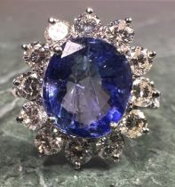 A certified sapphire and diamond ring, central purply blue mixed cut oval sapphire, 5.71ct,
