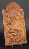 A South European cedar tabernacle door, carved with the Pieta, 38cm x 20cm, 18th/19th century