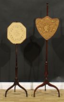 A 19th century mahogany tripod pole screen, shield shaped banner, 154cm high; another, similar (2)