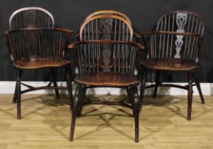 A near set of four 19th century yew, ash and elm Windsor elbow chairs, low hopped backs, pierced
