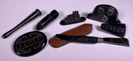 A Victorian Whitby Jet miniature model Abbey, a cheroot holder, fruit knife, whistle, Whitby