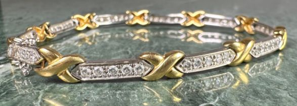 A diamond fancy X and bar link bracelet, composed of ten yellow gold X links and ten diamond