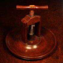 Nutcrackers - a 19th century mahogany table top screw-action nut cracker, corkscrew form handle,