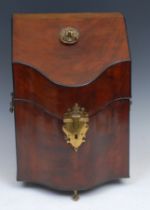A George II mahogany serpentine knife box, hinged sloping cover with axehead handle, enclosing a