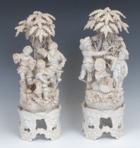 A pair of Italian figure groups and stands, modelled with revelling Bacchic infants, 38cm high,
