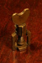 Nutcrackers - a late 17th century brass screw-action pocket corkscrew, heart shaped thumbpiece, 7.