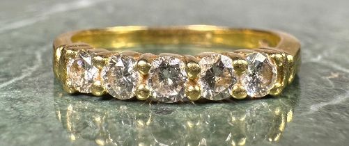 A diamond ring, linear set with five round brilliant cut diamonds, total estimated diamond weight