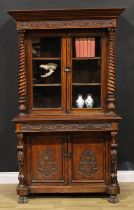 A 19th century Colonial teak library bookcase, outswept dentil cornice with foliate swag capital