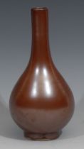 A Chinese monochrome ovoid bottle vase, glazed in tones of brown, 18cm high, six character and