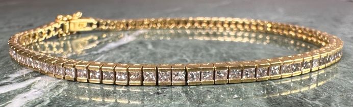 A Diamond tennis bracelet, set with eighty eight princess cut diamonds, total estimated diamond