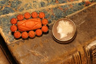 A 19th century coral brooch, gold coloured metal mount, 3cm wide; a cameo pendant (2)