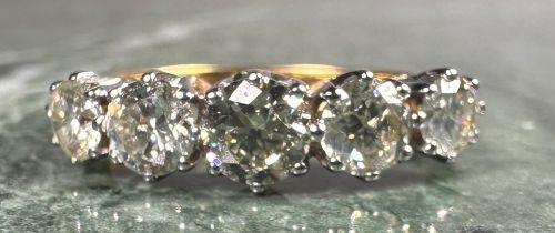 A certified diamond five stone ring, set with five round brilliant cut diamonds, colour J-K-L,