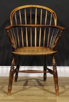 A 19th century beech, ash and elm Windsor elbow chair, hoop back, turned arm posts, turned legs, H-