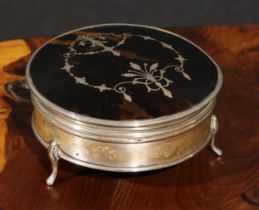 A George V silver, tortoiseshell and pique circular dressing table box, hinged cover, cabriole feet,