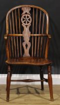 A 19th century beech, ash and elm wheelback Windsor elbow chair, hoop back, shaped and pierced