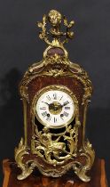 A Louis XV style gilt metal mounted faux tortoiseshell mantel clock, ivorine chapter ring, Roman
