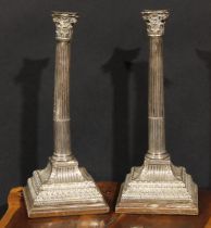 A pair of George III silver stop-fluted Corinthian column candlesticks, later mounted as table