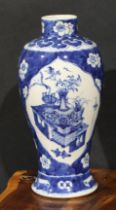 A Chinese baluster vase, painted in tones of underglaze blue with table sets with censers,
