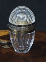 A French silver coloured metal mounted rock crystal faceted ovoid scent bottle, hinged cover