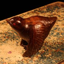 Alfred Lyndhurst Pocock (1882 - 1962), a hardwood carving, of a bird, ruby eyes, 6cm high, signed