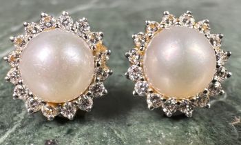 A pair of diamond and cultured pearl cluster earrings, central white cultured pearl surrounded by