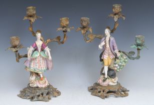 A pair of Derby figures, both dancing, wearing fancy dress, with lace trim, he with a lilac jacket