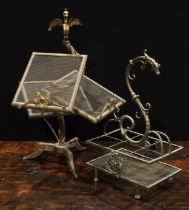 An unusual early 20th century brass periodical stand, wyvern finial above an asymmetrical