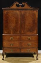 A 19th century fruitwood and marquetry cabinet on stand, swan neck pediment above a pair of