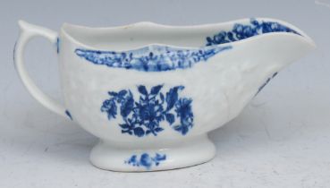 A Lowestoft cream boat, decorated in underglaze blue with flowers on a floral moulded ground, 12.5cm