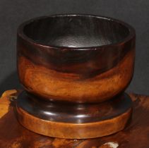 A 19th century lignum vitae bowl or mortar, 16cm high, 20.5cm diameter