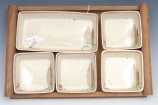 A Clarice Cliff hors d'oeuvre set, comprising one rectangular and four square dishes, printed marks,