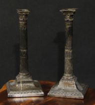 A pair of George III silver table candlesticks, Corinthian type capitals, stop-fluted pillars,