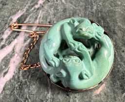 A Chinese circular turquoise brooch carved as two intertwined cats, 2.5cm in diameter, c.1900