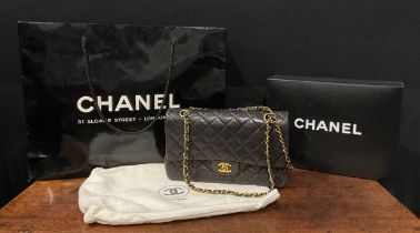 A Chanel quilted black lambskin leather handbag, double flap with burgundy leather interior,