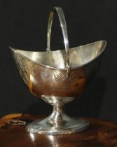 A George III Scottish silver boat shaped pedestal sugar basket, bright-cut engraved with swags and