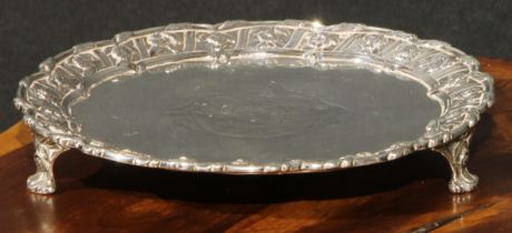 An early George III silver salver, the fluted border cast with flowers and stiff leaves, scroll