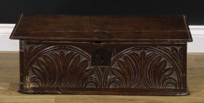 A 17th century oak boarded table box, hinged top, the front carved with leafy lunettes, 22.5cm high,