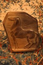 An Art Deco terracotta buckle, probably by Alfred Lyndhurst Pocock (1882 - 1962), in relief with a