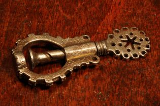Nutcrackers - a 17th century steel screw-action nut cracker, the shaped thumbpiece drilled and