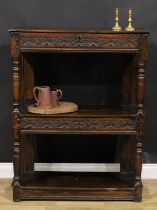 A 17th century oak cup-board, hinged top with notched border, each frieze carved with leafy