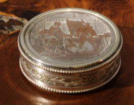 A 19th century French silvered snuff box, the cover engraved with a genre scene, Doux Propos