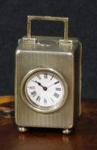 An Edwardian silver miniature carriage timepiece, the rectangular case engine turned overall, bun