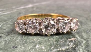 A diamond ring, set with five graduated round brilliant cut diamonds, total estimated diamond weight
