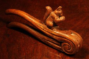 Nutcrackers - a Black Forest novelty lever-action nut cracker, carved as a squirrel on a branch,