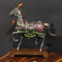 A Chinese silver and enamel model, of a horse ceremonially dressed, the bridle set with a