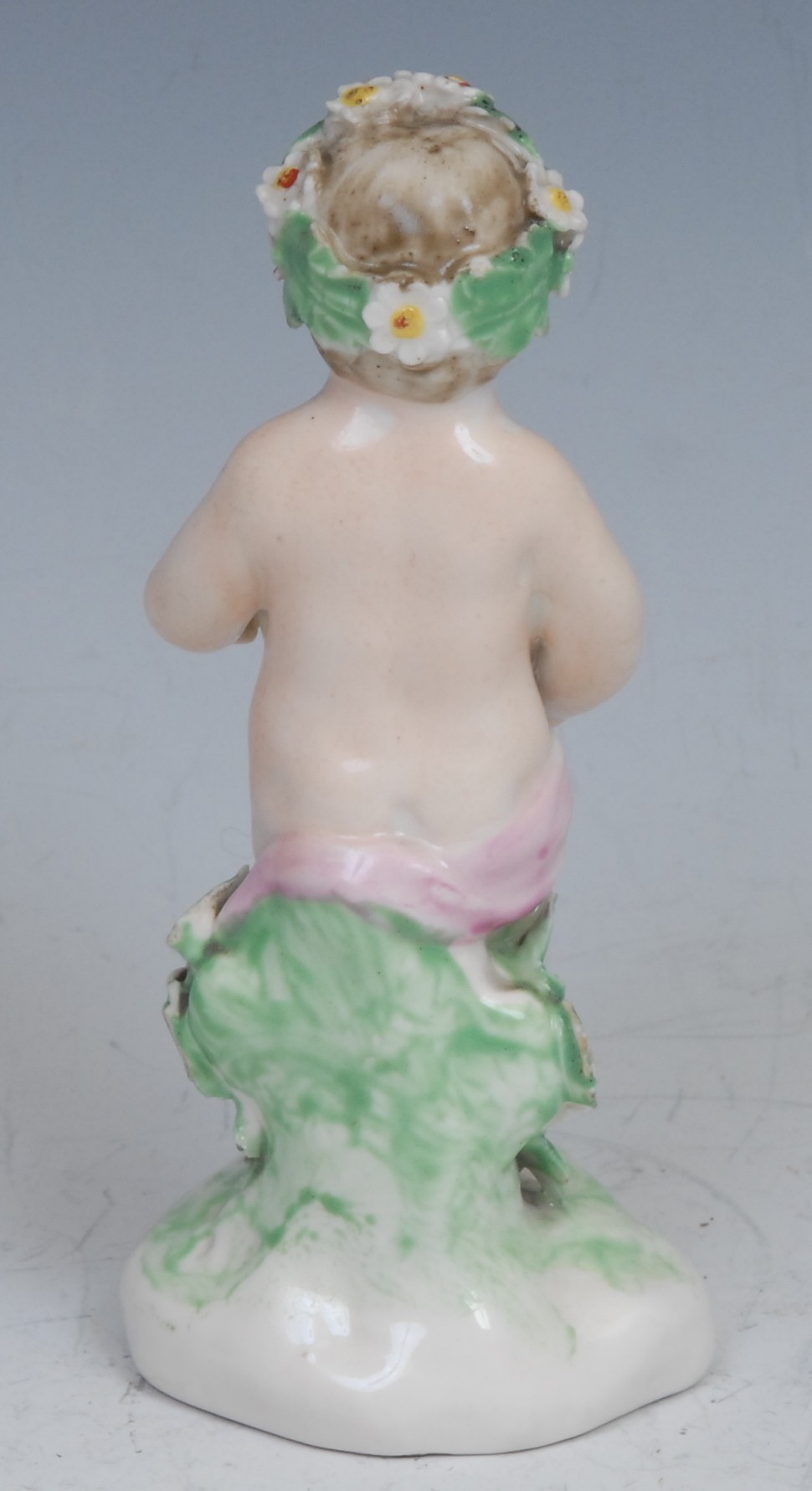 A Derby patch mark figure, Putto, garlanded with flowers, 10cm high, c.1780 - Image 2 of 3