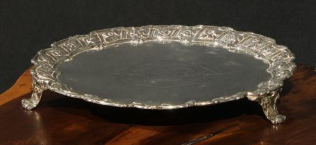 An early George III silver salver, the fluted border cast with flowers and stiff leaves, scroll